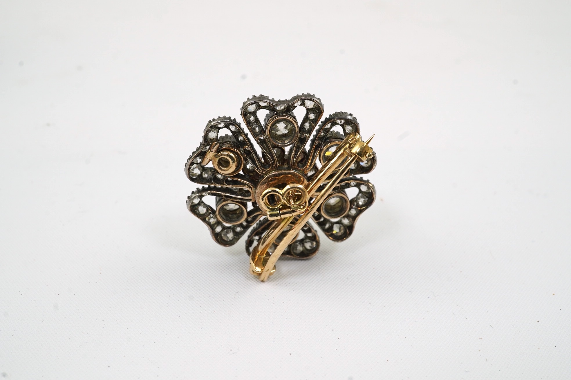 A Victorian gold, silver and diamond cluster set pendant brooch